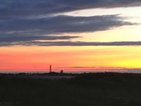 Sunset over Provincetown, Cape Cod, with the Pilgrim Monument visible in the distance