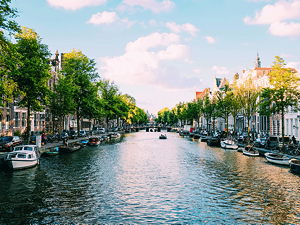 The canals in Amsterdam under calm blue sky