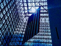 The atrium of the JFK Presidential library displays a large American flag