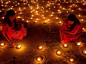 People light candle and clay lamps