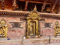 The golden entrance and statues of Durbar Square