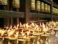 Oil lamps and prayer wheels at Boudhanath