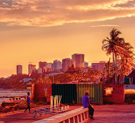 A man watching the sunset at Maputo's sea front