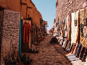 A side street at Aït Benhaddou ksar, on the walls carpets made by the local residents
