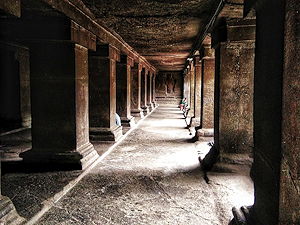 A passage with stone pillars inside the Pataleshwar temple