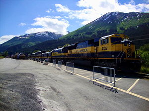 Alaska Railroad passenger train idles at Seward, Alaska, USA depot.